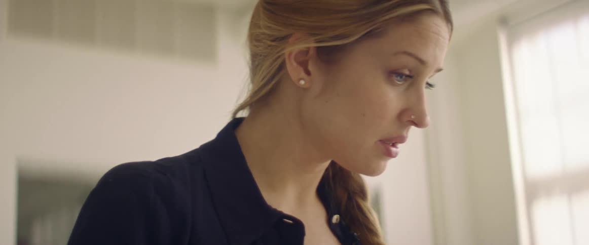 A woman talking while standing indoors