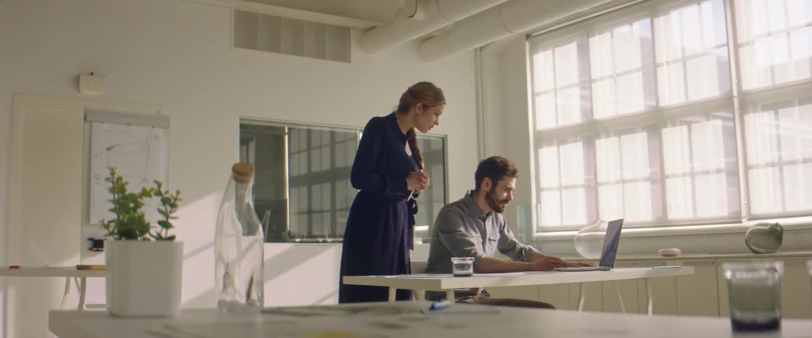 Two people talk in the office