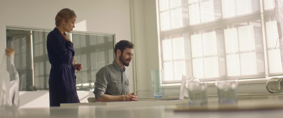 Two coworkers talk in the office