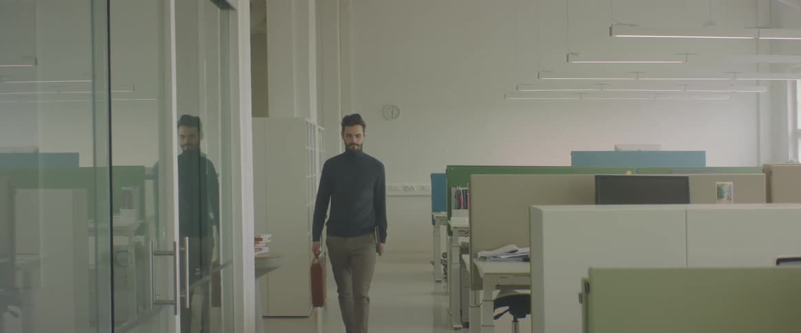 An employee enters the empty office
