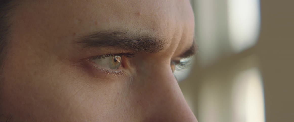 A closeup view of a mans face is displayed