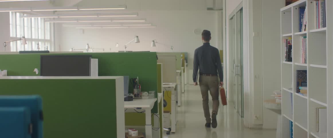 A man walks into the empty office