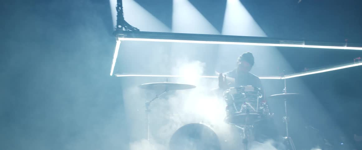 A man playing drums on a stage