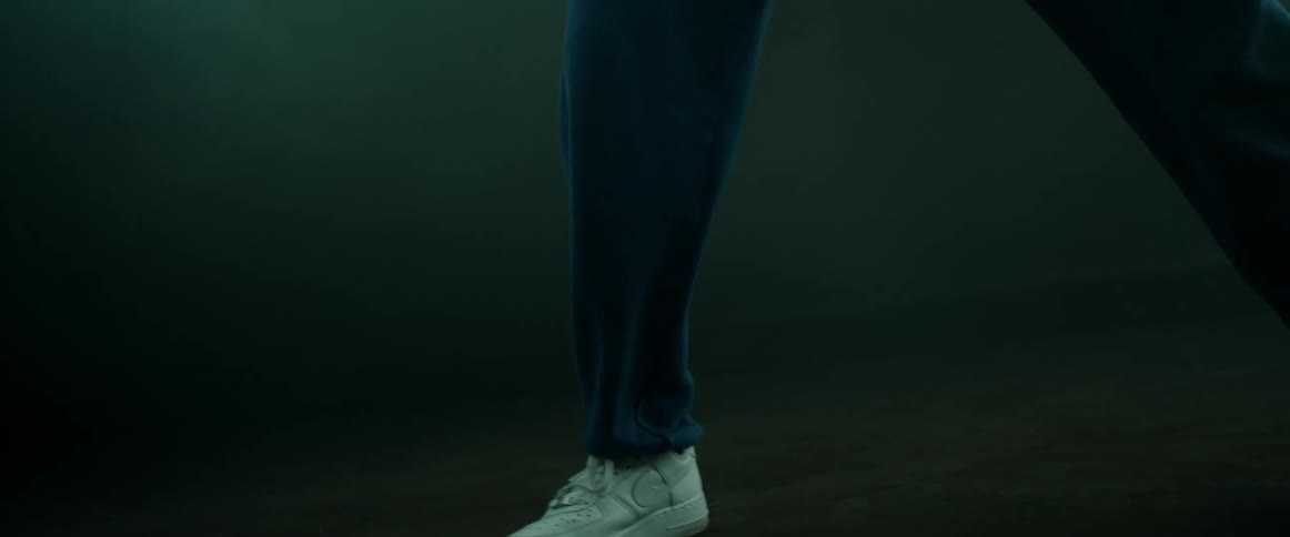 A person is wearing tennis shoes and dancing