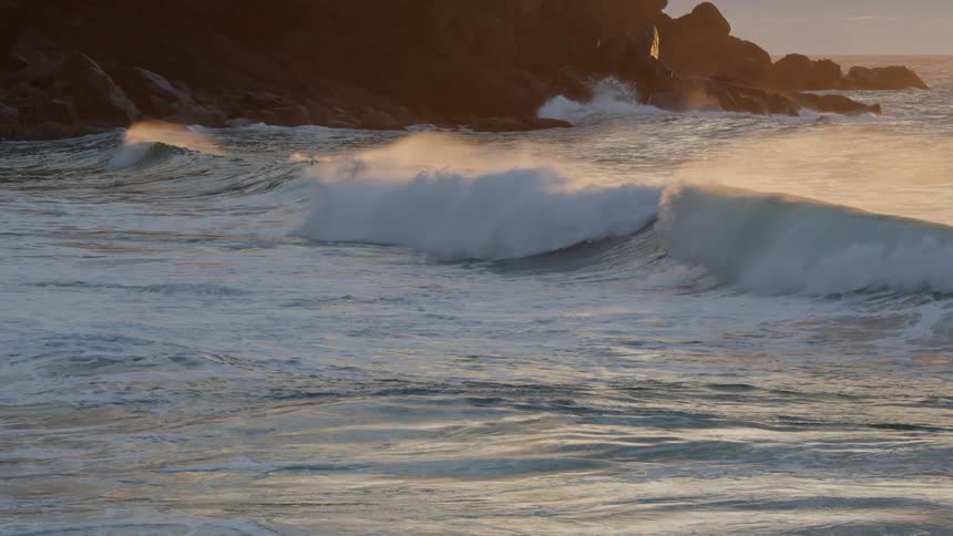 Waves rolling in along a rocky coastline