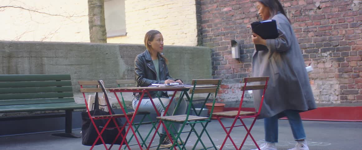 Two friends are sitting at a table and talking