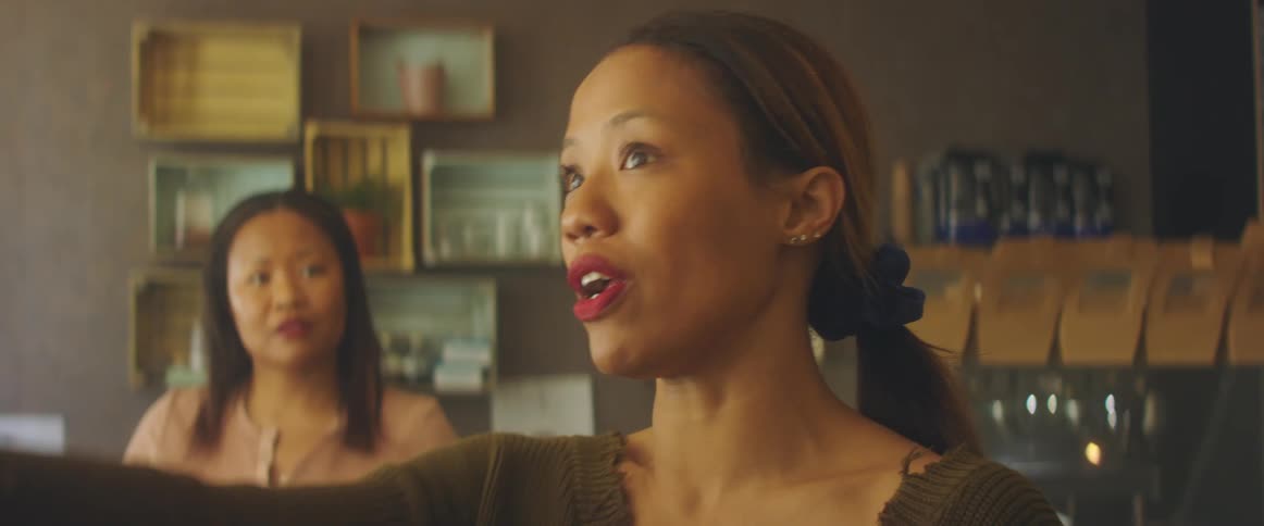 Two women standing around talking