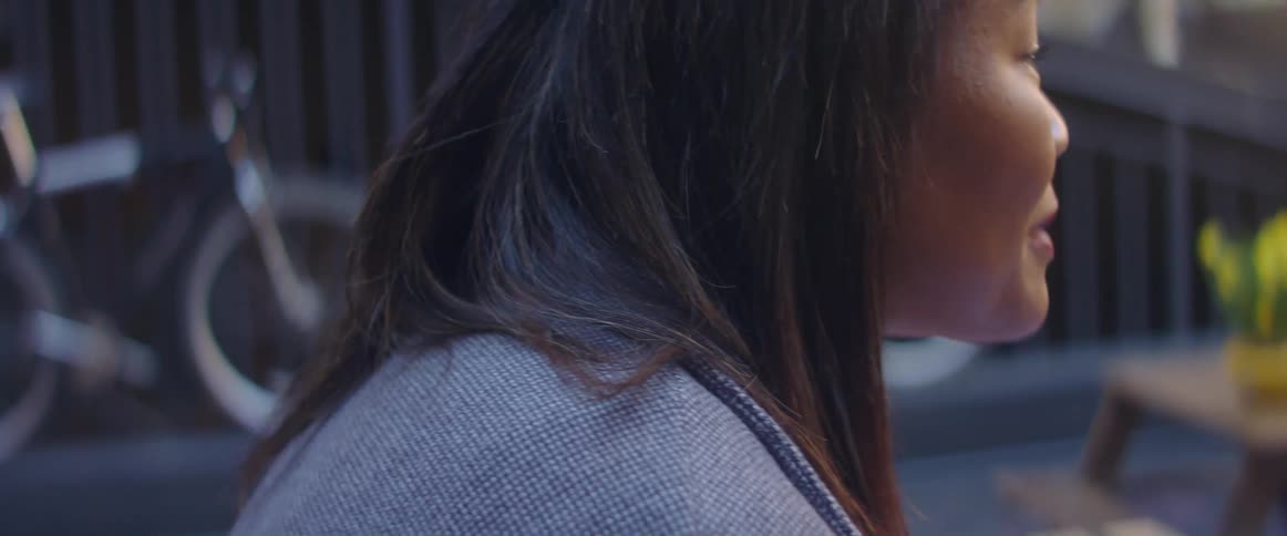 A woman is talking and smiling outside