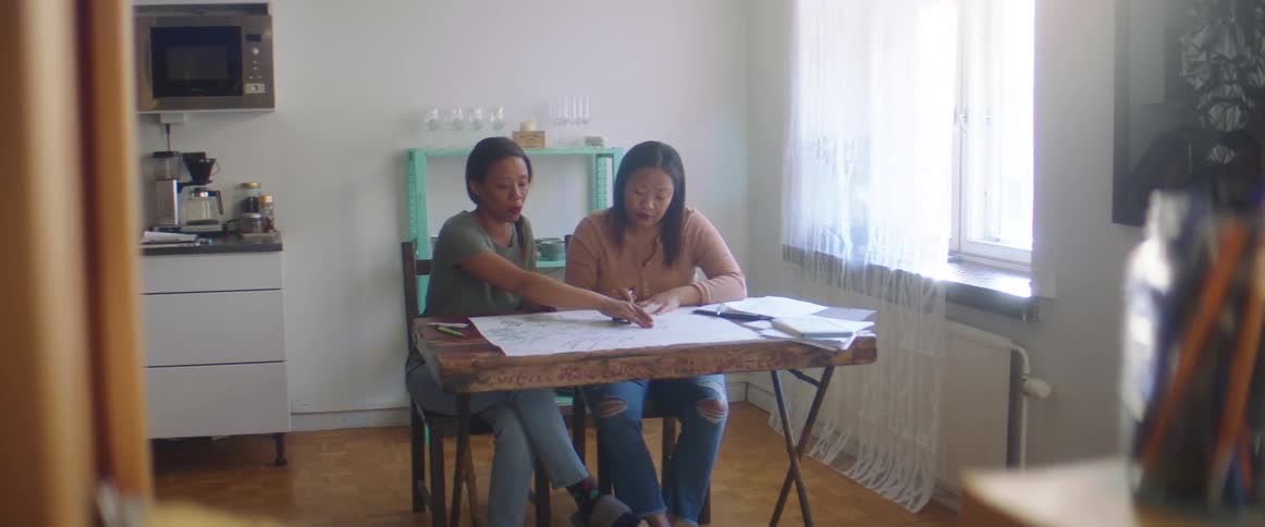 Two women sitting at a table talking