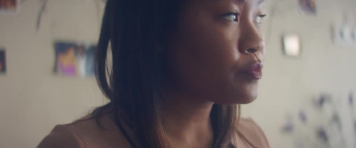 A woman is standing in a room during the day