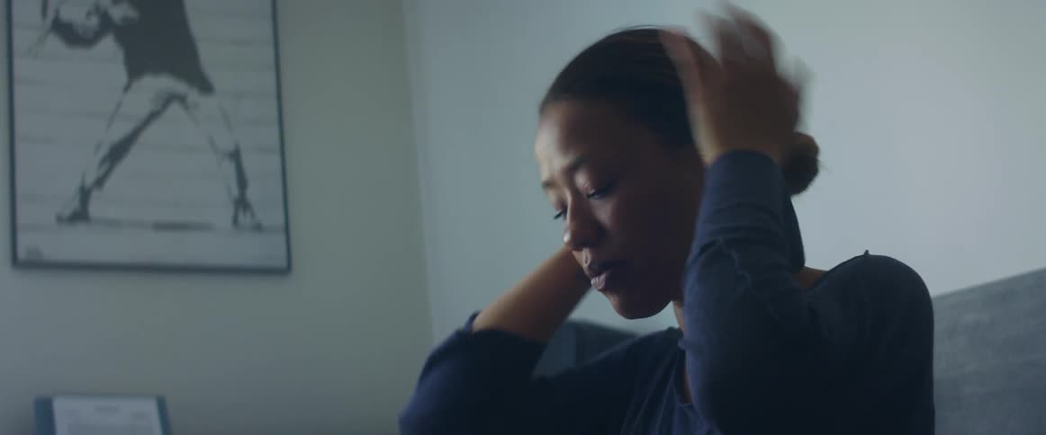 A woman puts on a hair tie
