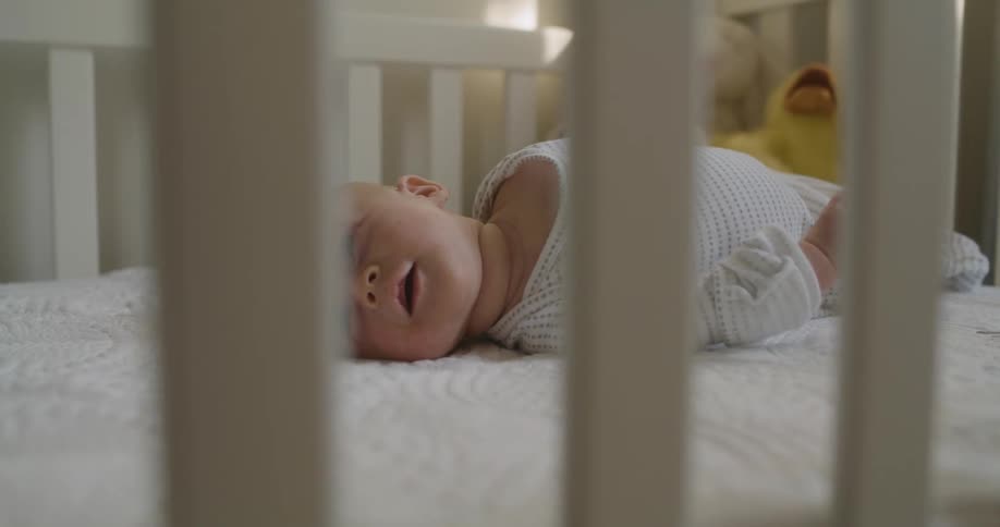 A baby laying in a crib