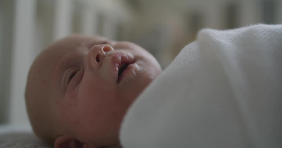 A baby sleeping in a crib