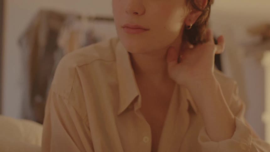 A portrait of a woman sitting in a room