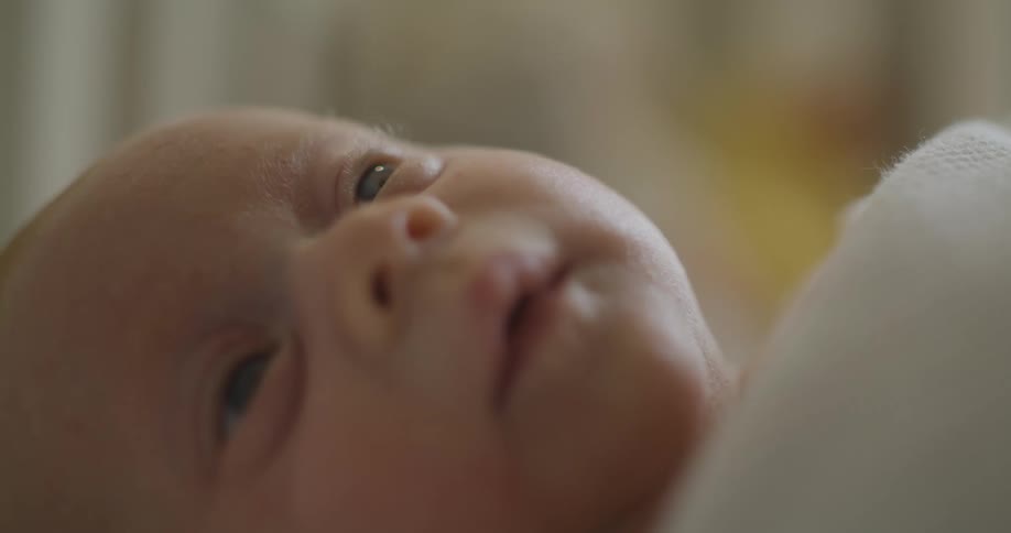 A baby is resting in the crib