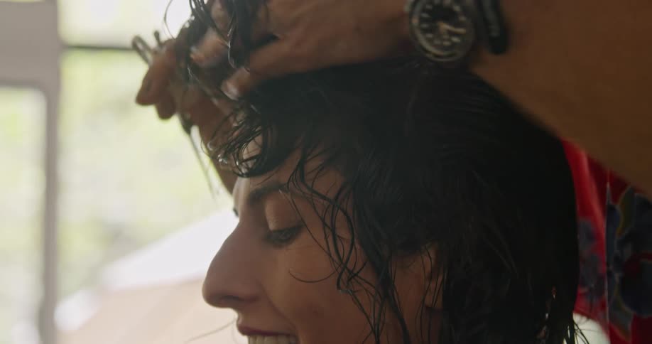 Stylist giving a haircut to a client in the salon