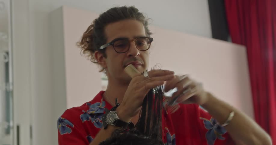 A man cutting a womans hair