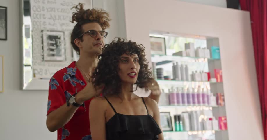 A man doing a womans hair in a salon