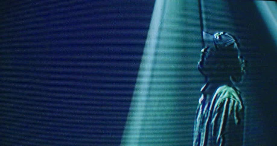 Digital effects and static affect screen image of person standing on stage under colored lights