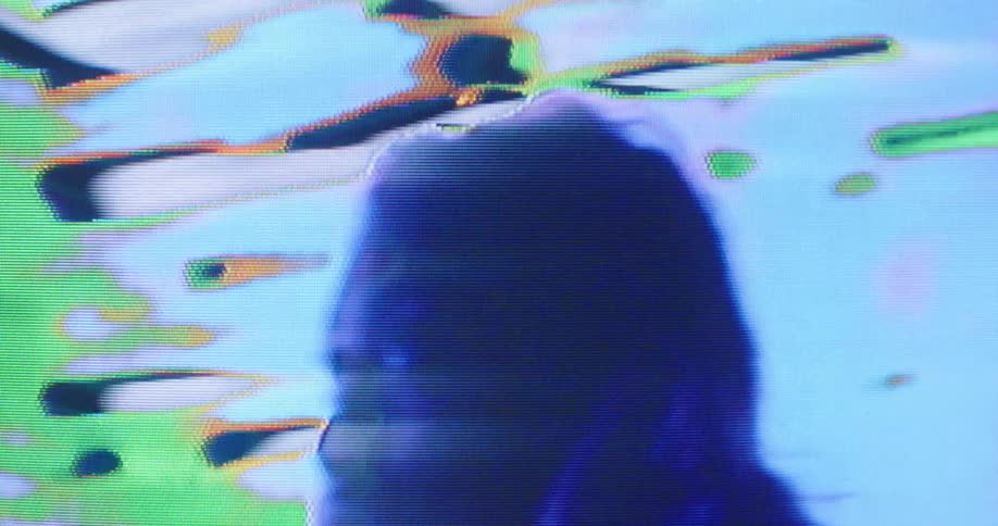 A woman and flashing colors on a digital screen