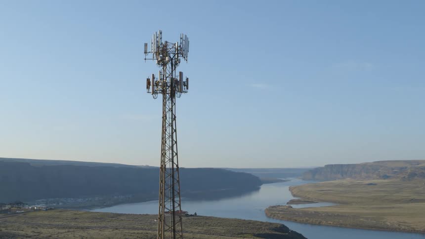 A tall cellular data tower serves a rural community