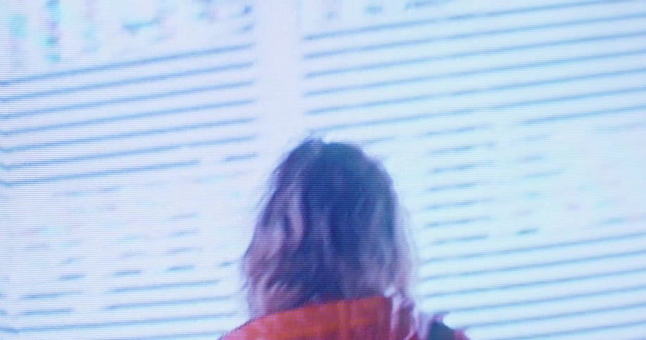 A woman is looking around the wall display