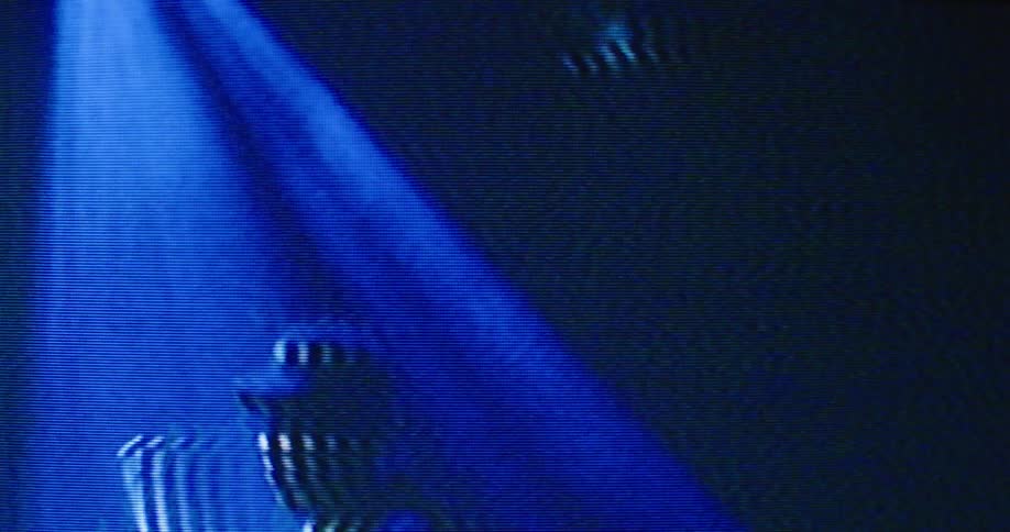 A man is playing drums on the blurry display