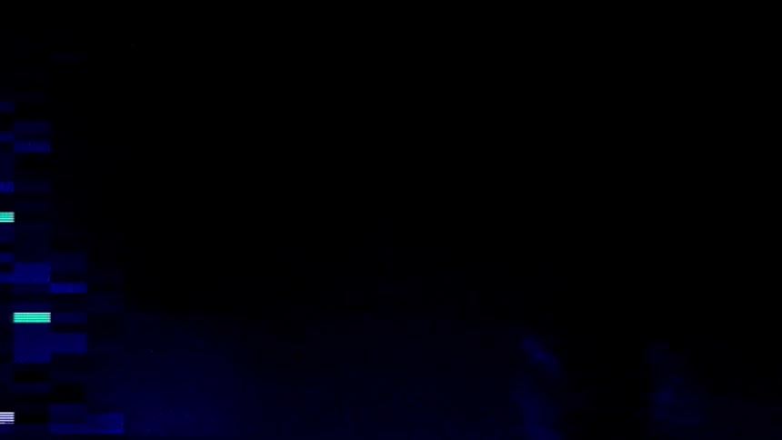 A person standing by glowing blue lights in darkness