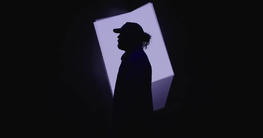 A man is shown standing by a digital shape
