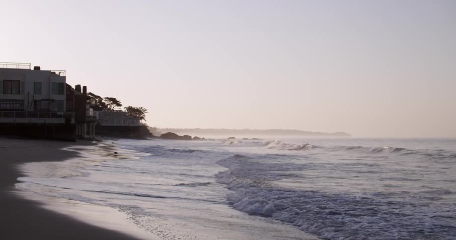 Gentle waves coming up on shore on a clear day