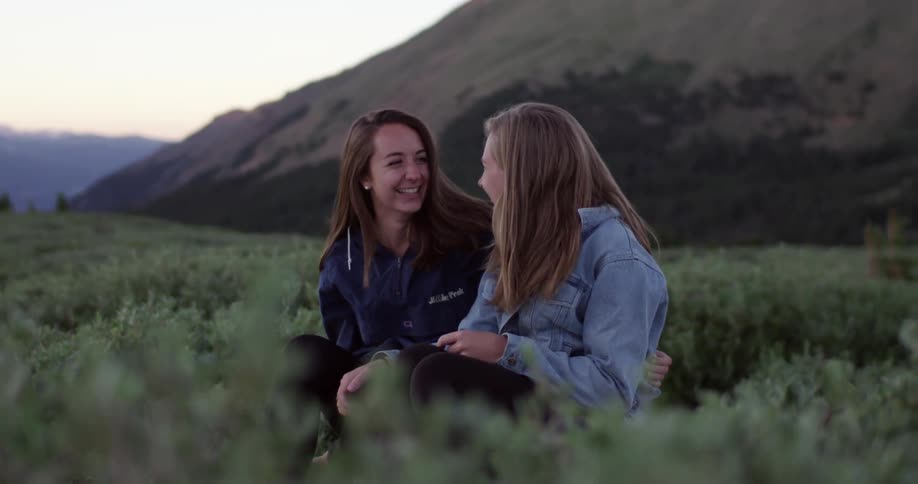 Two friends sitting and laughing together