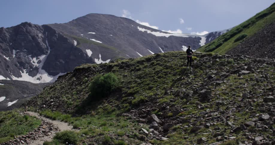 A man is hiking on the top of a mountain