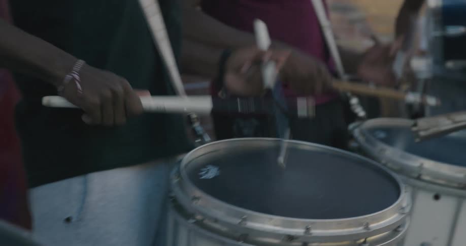 Musicians are playing a song on drums