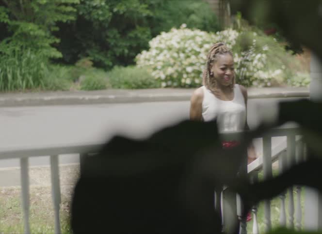 A woman is walking towards a house