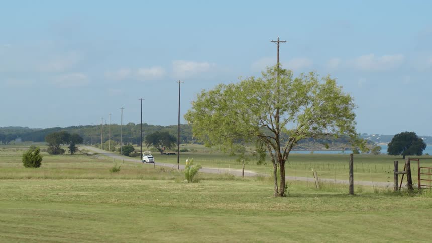 Car towing a boat on a road in the coutryside at daytime