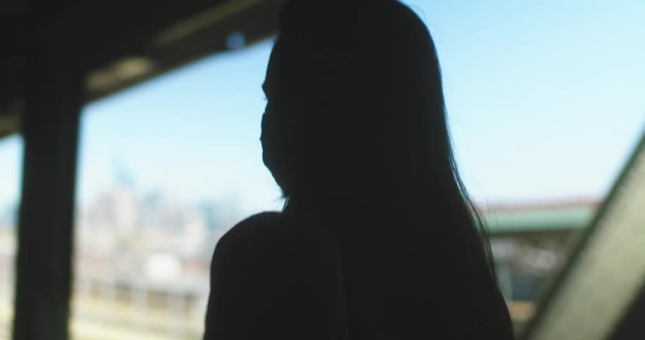 A woman is walking on the train platform