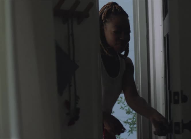 A woman walking through a front door
