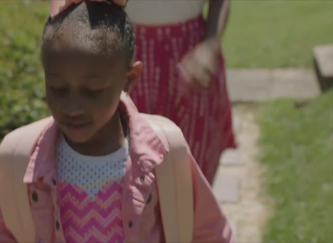 A mother and daughter walking out of their house