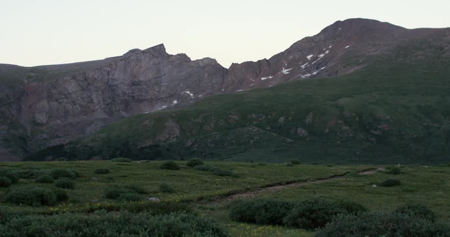 View of a green field before a mountain