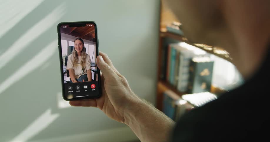 A man and woman chatting via video call on a smartphone