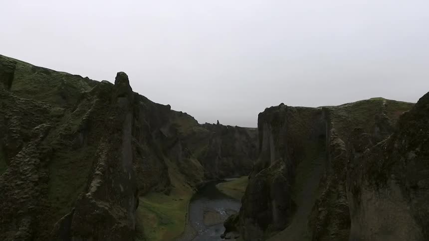 A river between mountains on a overcast day