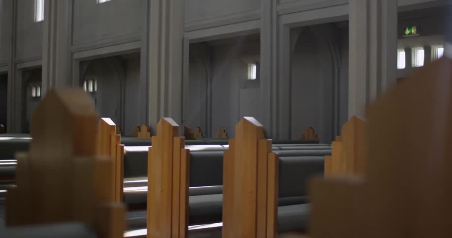 Church pews inside of a sunny church