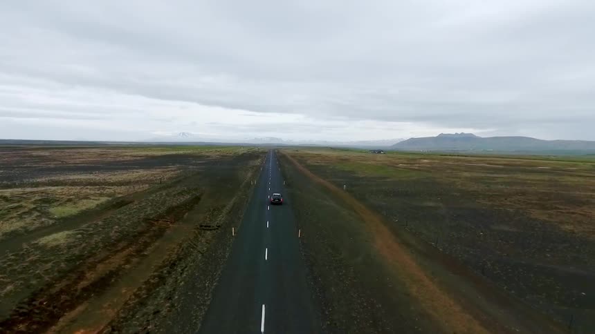 A single car goes down a long small road