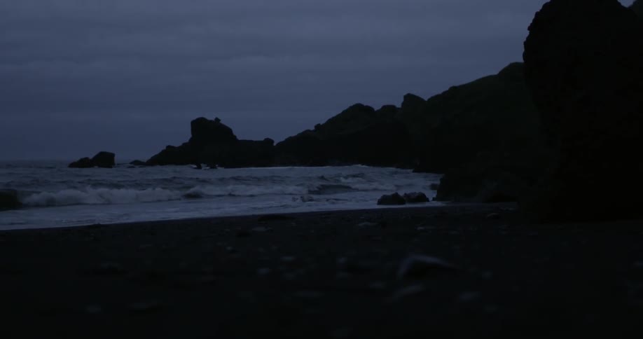 Ocean waves splashing to shore at sunset