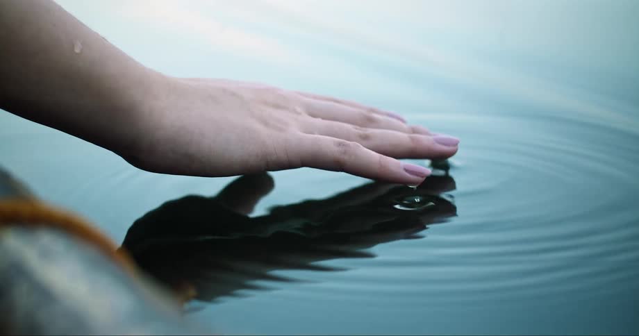 Hand touching the water
