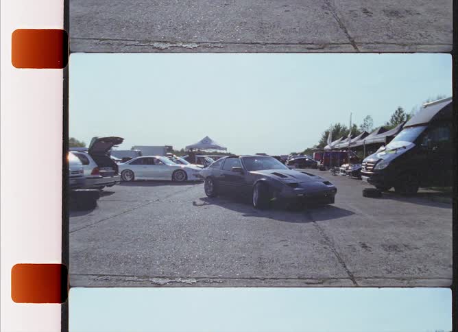 A filmstrip with a race car driver pulling a care out of a parking space