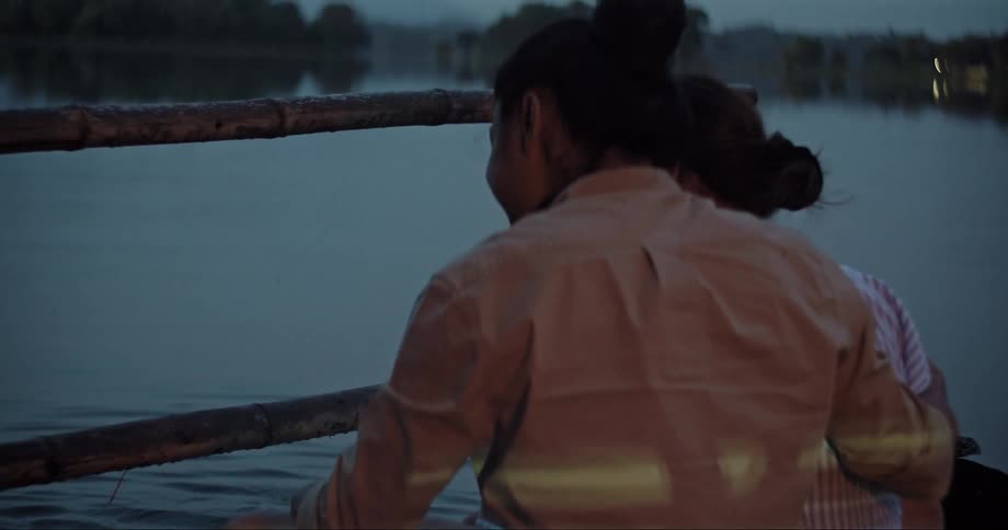 A couple sitting by the lakeshore