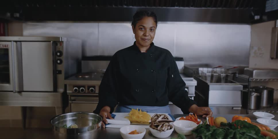 A woman in a restaurants kitchen
