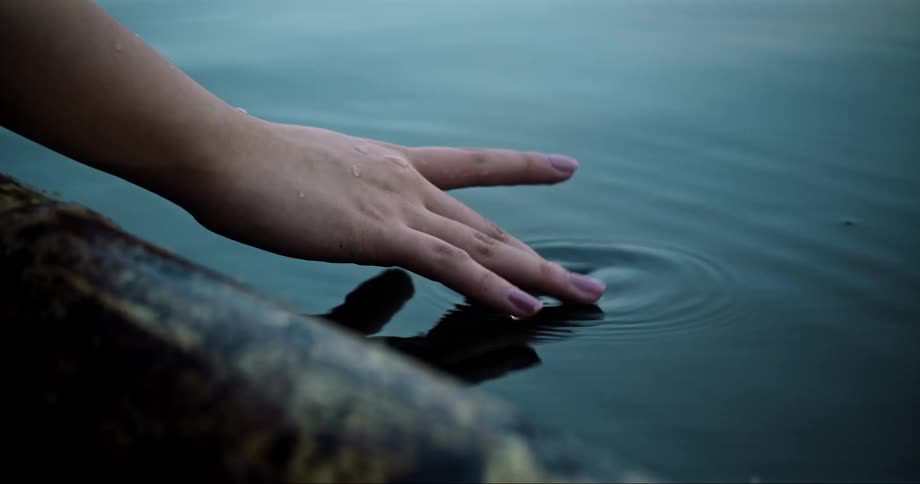 Hand touching the water