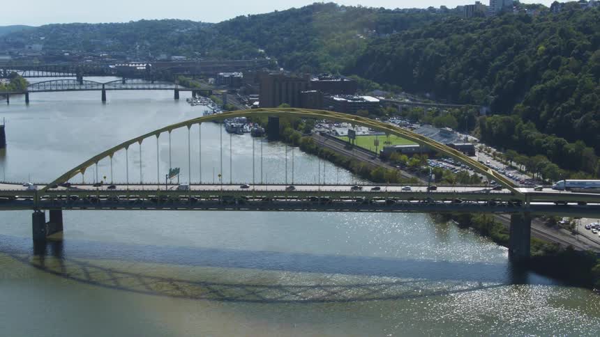 Vehicles travel over both bridges heading to the city